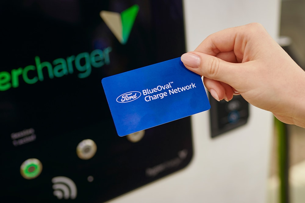 A BlueOval™ Charge Network card (RFID) being used at a public EV charging station for easy payment.