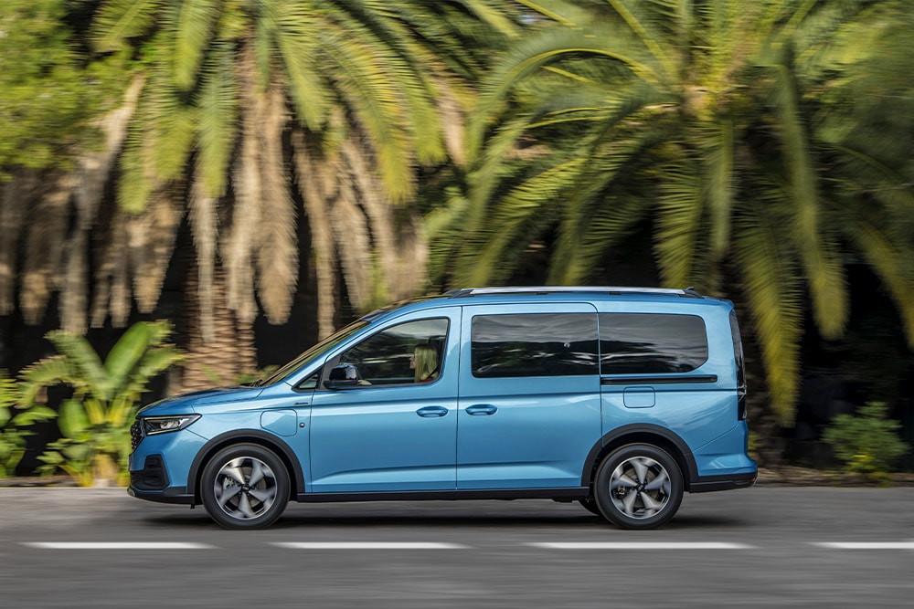 A blue Ford Tourneo Connect plug-in hybrid van parked on a street.