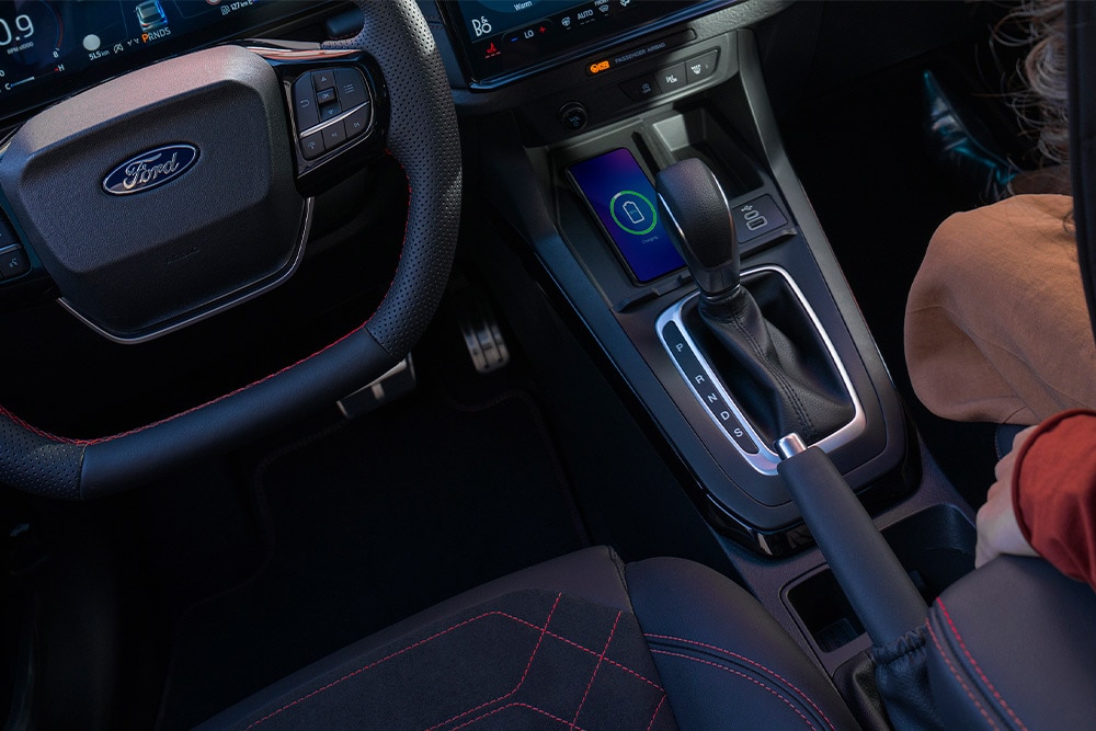 An interior view of a Ford mild hybrid car, including steering wheel and automatic gear stick. 