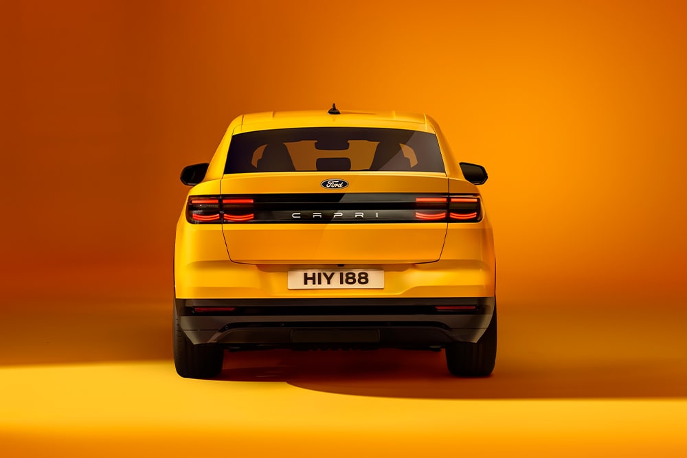 The rear of the new Ford Capri® in yellow, photographed in a yellow studio.