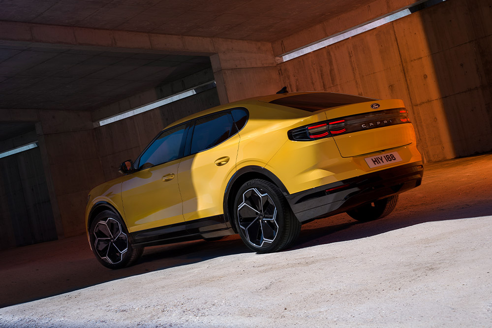 Rear view of a yellow Ford Capri in a parking garage.