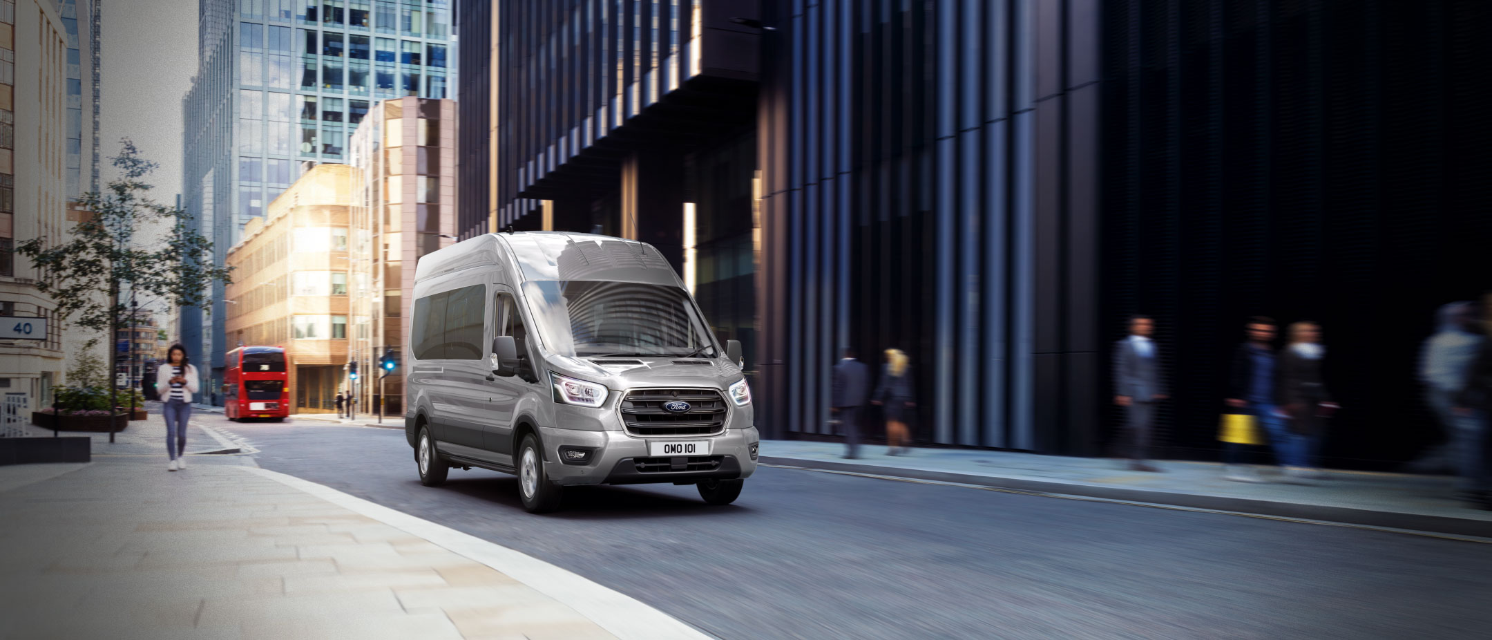 Front view of the new Ford Transit Minibus driving on a quiet road in London