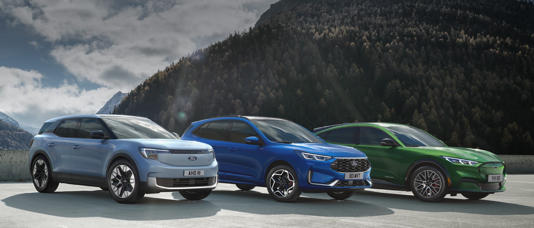 Puma Kuga white and blue by mountains